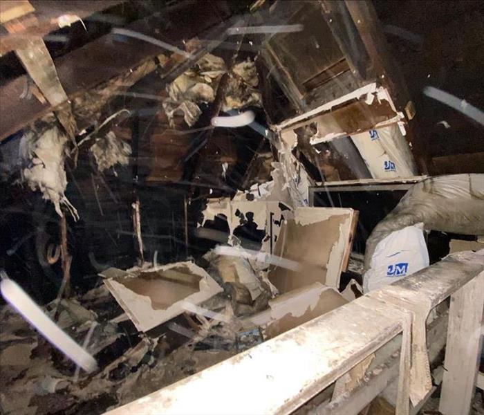 Charred debris in a home with wood and items 