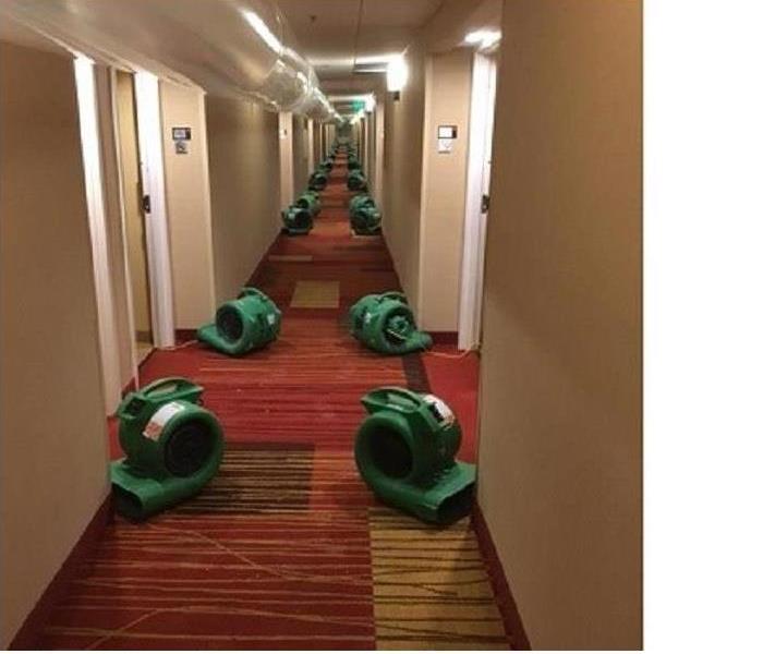 rows of air movers--green in a hallway, about 35 feet running