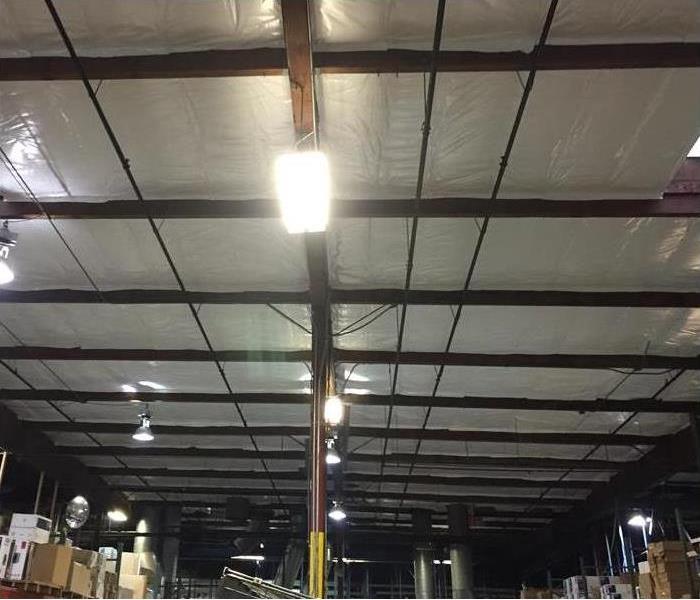 Warehouse ceiling with evidence of smoke and fire damage 