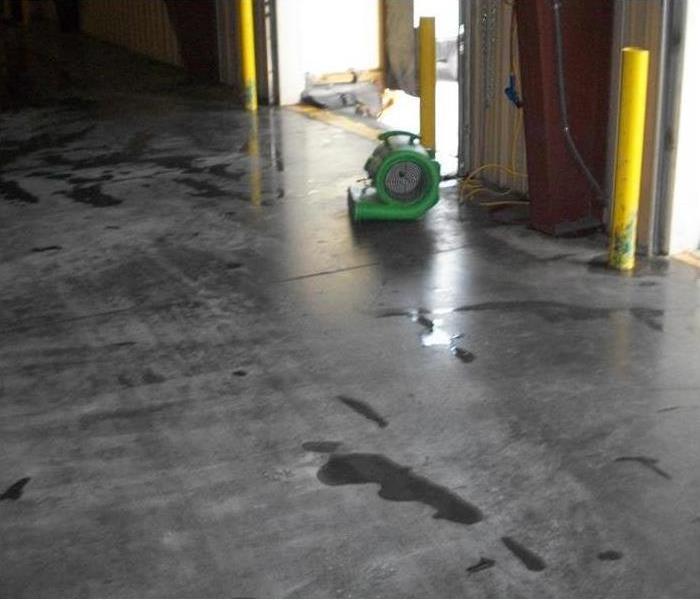 air mover on concrete floor by bay door opening