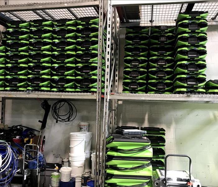 SERVPRO equipment stacked above and under a shelf.