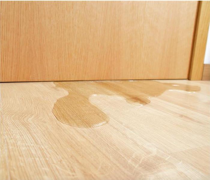 water intruding under office door on wood floor