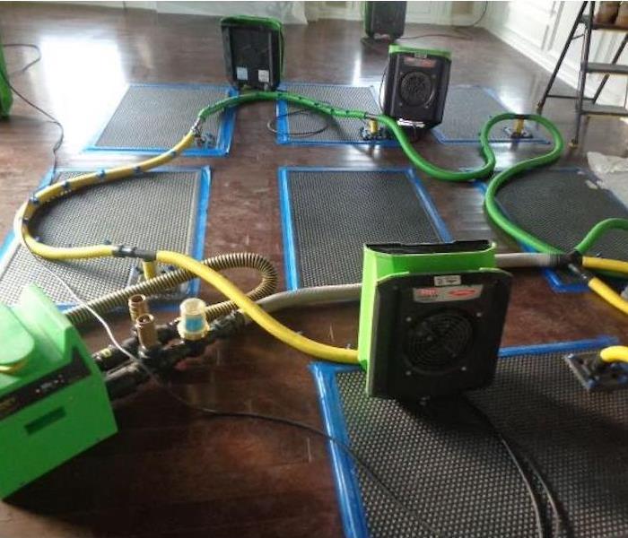 SERVPRO drying equipment on a tile floor in a business